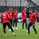 Beşiktaş players training under the watchful eye of their coach