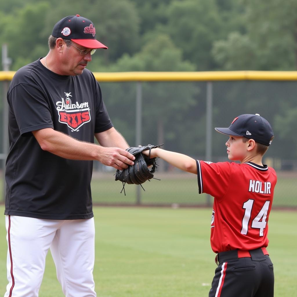 A coach providing one-on-one pitching instruction at Anderson University Baseball Camp