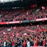 Besiktas fans passionately chanting and waving flags inside Vodafone Park stadium.