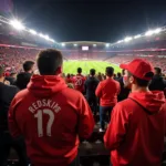 Besiktas fans fill Vodafone Park, a sea of black and white with pops of red from Redskins hoodies, creating an electric atmosphere.