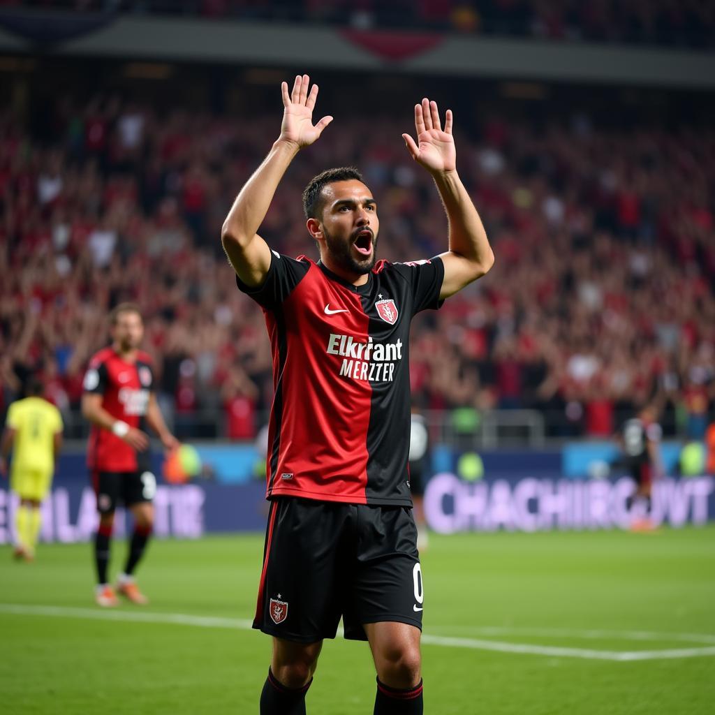 A Besiktas player celebrates a goal with the winning glove gesture in front of the passionate fans.