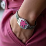 Close up of a breast cancer medical alert bracelet