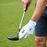 Golfer wearing a vegan golf glove while addressing the ball