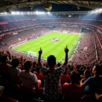 Beşiktaş fans in Hawaiian shirts cheering in the stands