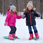 Kids wearing ice cream sliding mitt youth having fun in the snow