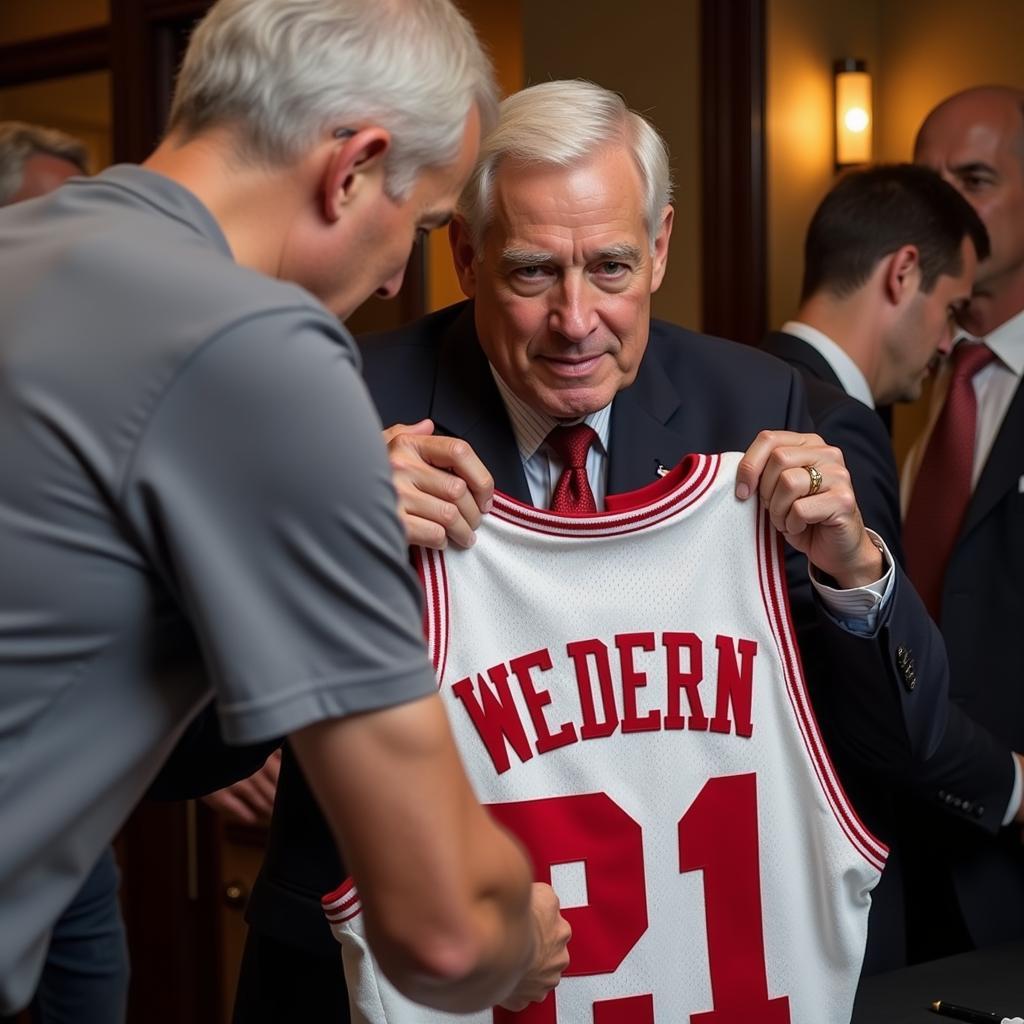 Jerry West Signing a Jersey