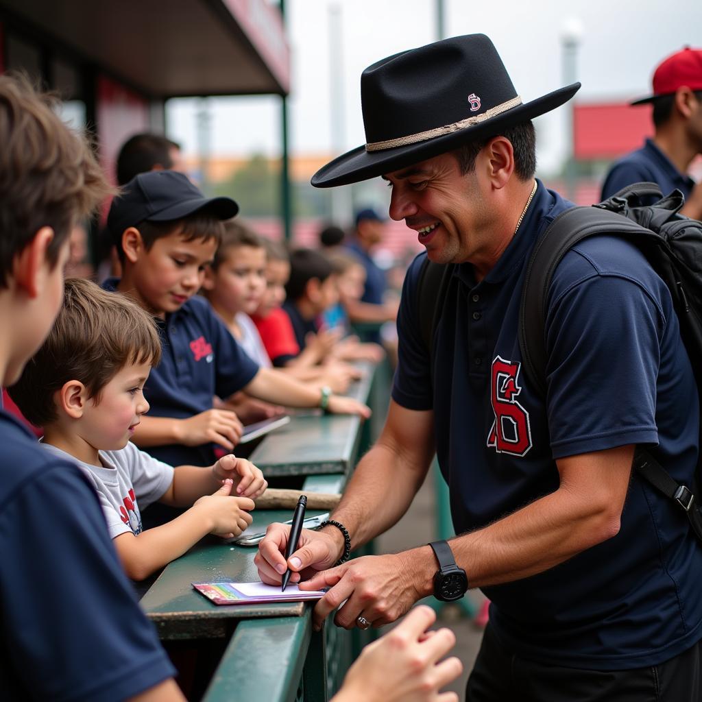 Julio Rodriguez taking the time to sign autographs for young fans before a game