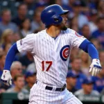 Kris Bryant swinging a bat in a Chicago Cubs jersey