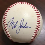 Close-up of a Michael Jordan autographed baseball showing details of the signature and the baseball's condition