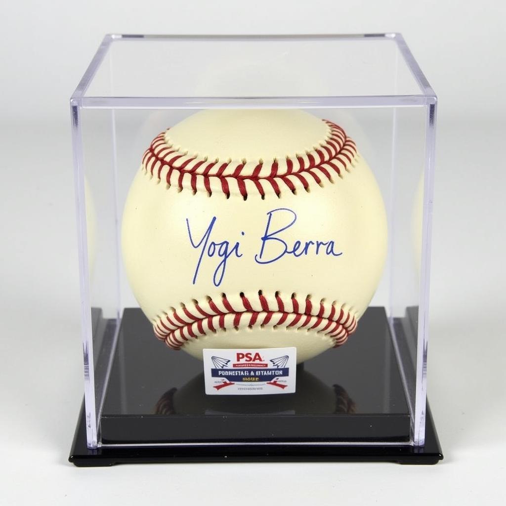 Yogi Berra autographed baseball displayed in a PSA authentication case