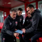 Besiktas coaching staff using the dugout mister system during a match