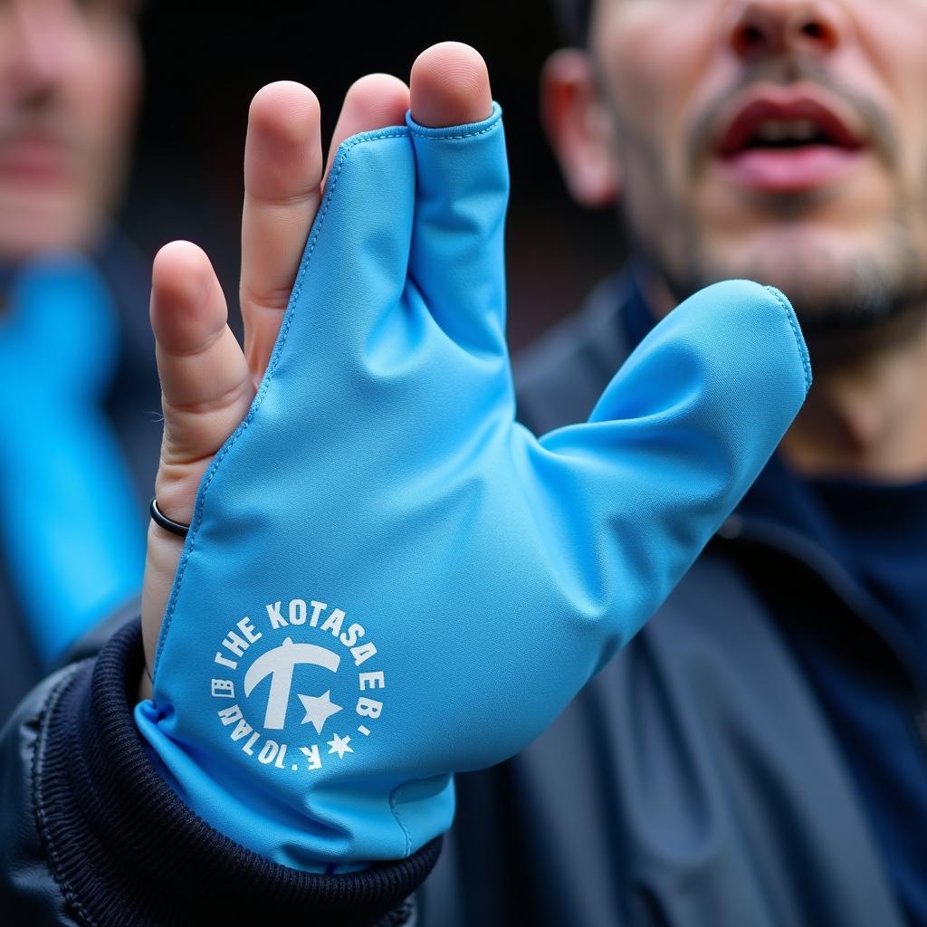 A Besiktas fan displaying their baby blue sliding mit with pride