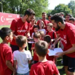 Besiktas players and fans participating in a charity event at Crawford Park