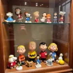 Peanuts figurines displayed in a protective case