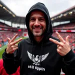 Besiktas fan wearing a black still tippin hoodie with the club's eagle emblem prominently displayed.